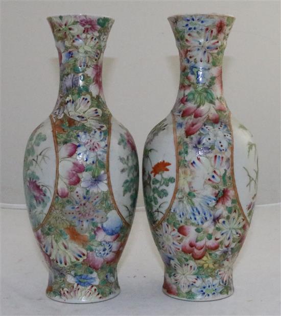 A pair of Chinese famille rose millefleur bottle vases, early 20th century, 24.5cm